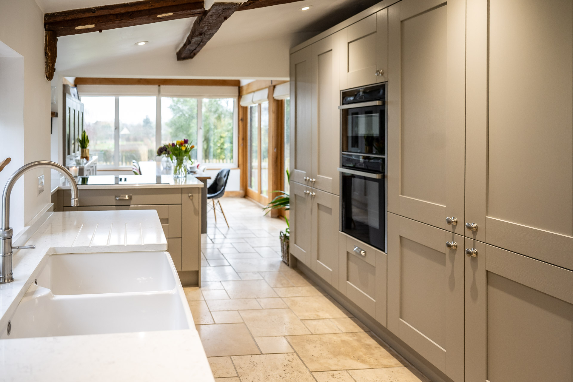 Modern bespoke kitchen with grey cabinetry.
